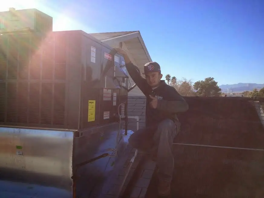HVAC technician performing HVAC Inspection on a rooftop unit in Rancho Cucamonga